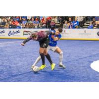 St. Louis Ambush forward Robert Kristo fends off a Kansas City Comets defender