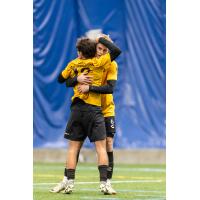 Pittsburgh Riverhounds SC defender Max Broughton and midfielder Charles Ahl celebrate