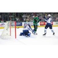 Manitoba Moose' Domenic DiVincentiis and Ashton Sautner and Texas Stars' Justin Hryckowian on the ice