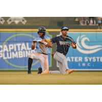 Roni Cabrera of the Columbia Fireflies (left) reacts after beating the tag