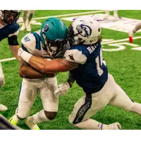 Jacksonville Sharks make a tackle against the Massachusetts Pirates