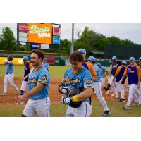 Colton Ledbetter (right) and the Montgomery Biscuits walk off the field