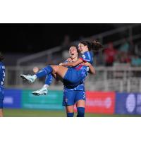 Kaleigh Kurtz carries Ryan Williams of the North Carolina Courage